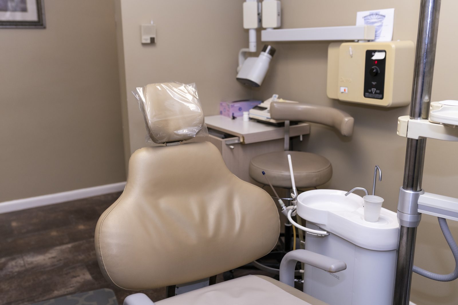 A treatment room set up and ready, with the instrument tray beside the chair